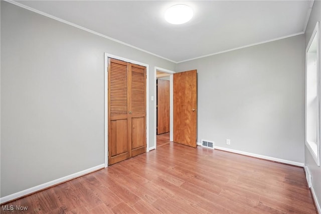 298 W Chestnut St, Lisbon, OH 44432 - unfurnished bedroom with ornamental molding, a closet, wood finished floors, and baseboards