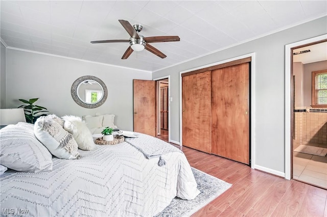 298 W Chestnut St, Lisbon, OH 44432 - bedroom featuring ornamental molding, light wood-style flooring, ensuite bath, ceiling fan, and a closet