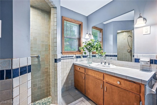 298 W Chestnut St, Lisbon, OH 44432 - bathroom with tile walls, tiled shower, vanity, tile patterned floors, and a wainscoted wall