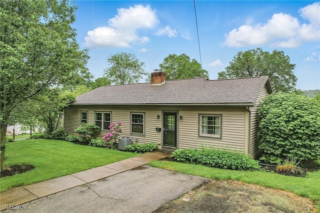 298 W Chestnut St, Lisbon, OH 44432 - single story home with a chimney, a front lawn, and a shingled roof