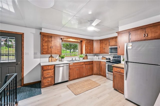 298 W Chestnut St, Lisbon, OH 44432 - kitchen with stainless steel appliances, light wood-style flooring, light countertops, and a sink
