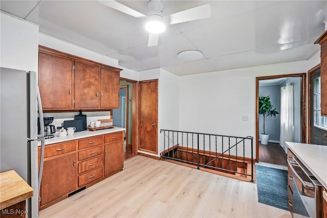 298 W Chestnut St, Lisbon, OH 44432 - kitchen featuring freestanding refrigerator, light wood-style floors, light countertops, and ceiling fan