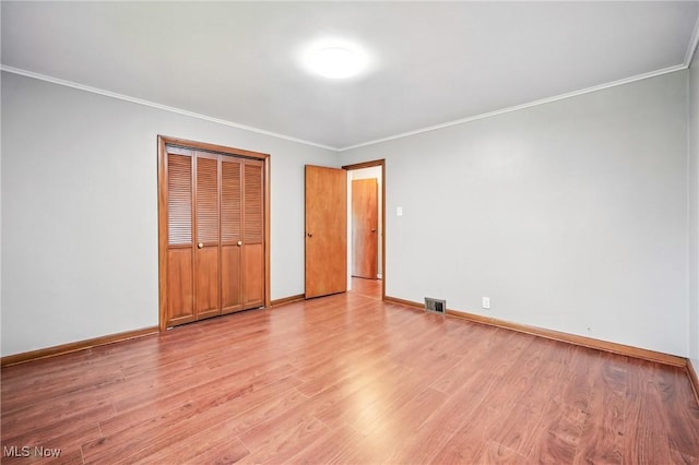 298 W Chestnut St, Lisbon, OH 44432 - unfurnished bedroom with light wood-style flooring, ornamental molding, baseboards, and a closet