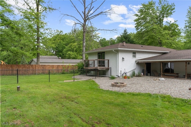17801 Ellsworth Rd, Lake Milton, OH 44429 - rear view of property with stucco siding and an outdoor fire pit