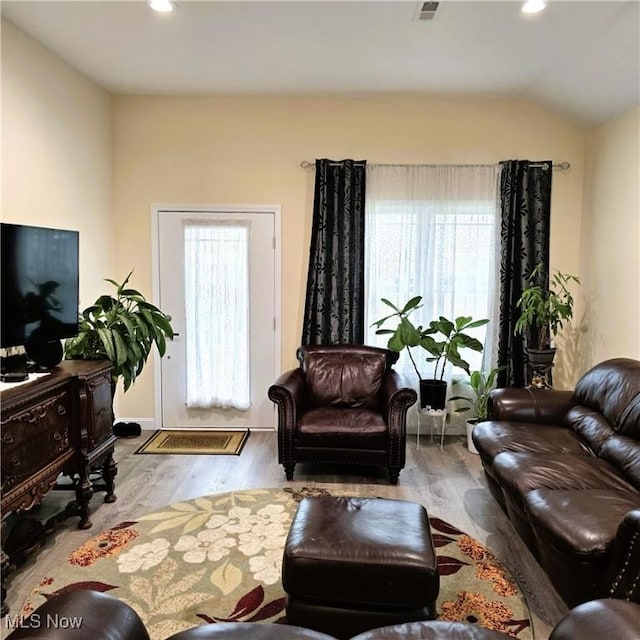 6363 Lockhaven Dr, Brook Park, OH 44142 - living room featuring plenty of natural light, wood finished floors, recessed lighting, and lofted ceiling