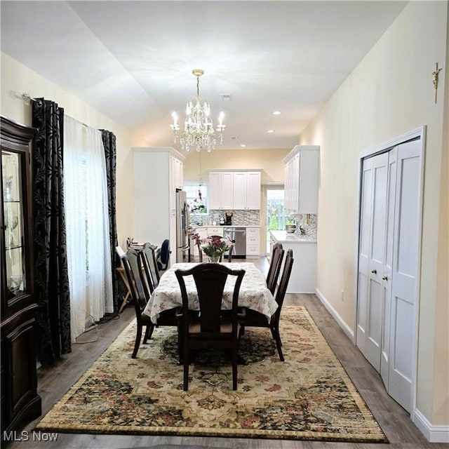 6363 Lockhaven Dr, Brook Park, OH 44142 - dining room with a chandelier, wood finished floors, and lofted ceiling