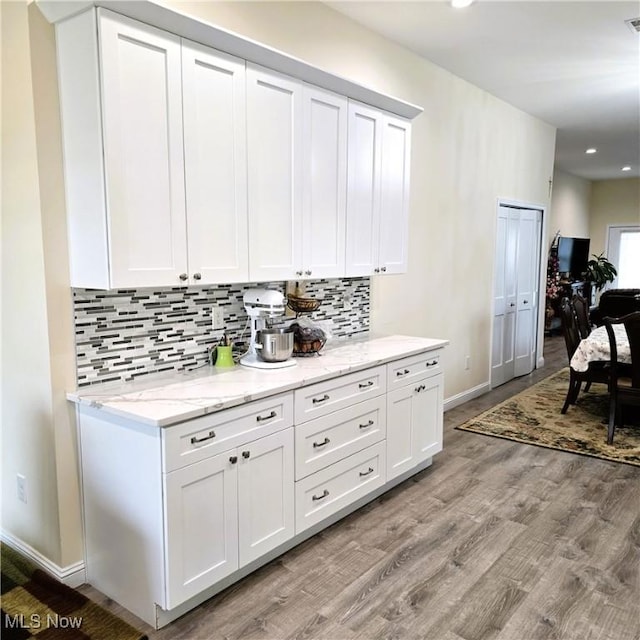 6363 Lockhaven Dr, Brook Park, OH 44142 - kitchen featuring baseboards, decorative backsplash, white cabinetry, and recessed lighting