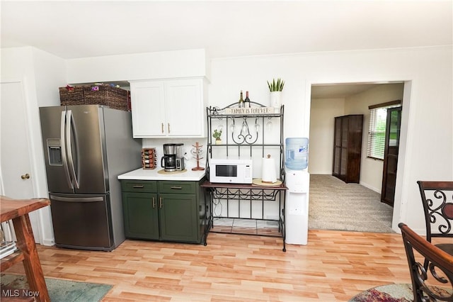 1087 Madrid Dr, Akron, OH 44313 - kitchen featuring stainless steel fridge, white microwave, green cabinetry, light wood-type flooring, and white cabinetry