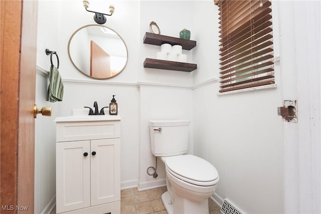 1087 Madrid Dr, Akron, OH 44313 - bathroom with vanity, toilet, baseboards, and tile patterned flooring