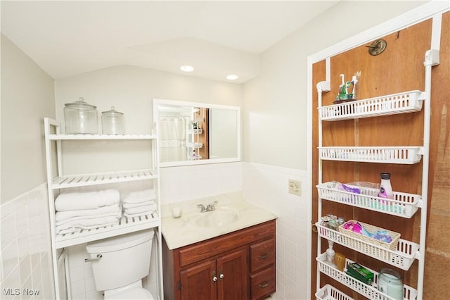 1087 Madrid Dr, Akron, OH 44313 - bathroom featuring vanity, a wainscoted wall, toilet, tile walls, and recessed lighting