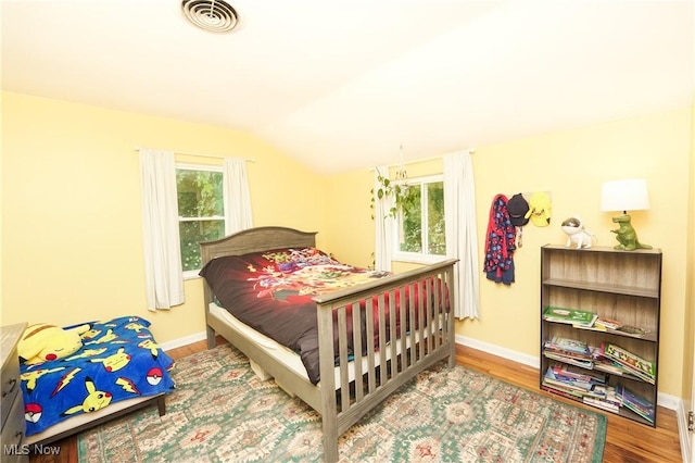 1087 Madrid Dr, Akron, OH 44313 - bedroom featuring wood finished floors, lofted ceiling, and baseboards