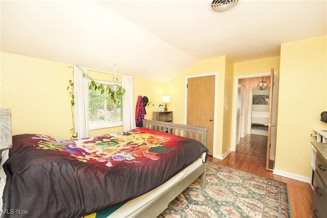 1087 Madrid Dr, Akron, OH 44313 - bedroom with wood finished floors, vaulted ceiling, and baseboards