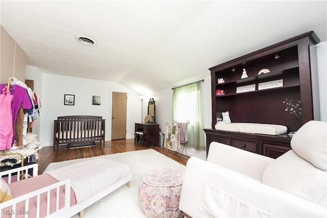 1087 Madrid Dr, Akron, OH 44313 - living room featuring wood finished floors, lofted ceiling, and a wood stove