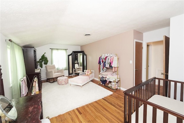 1087 Madrid Dr, Akron, OH 44313 - living area featuring light wood-type flooring, baseboards, and vaulted ceiling