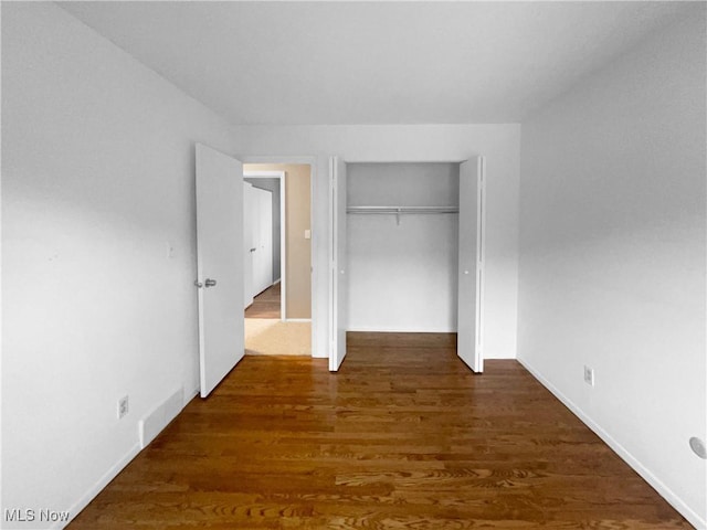 2330 Judy Dr, Parma, OH 44134 - unfurnished bedroom with wood finished floors, a closet, and baseboards