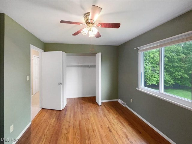 2330 Judy Dr, Parma, OH 44134 - unfurnished bedroom featuring baseboards, wood finished floors, a closet, and ceiling fan