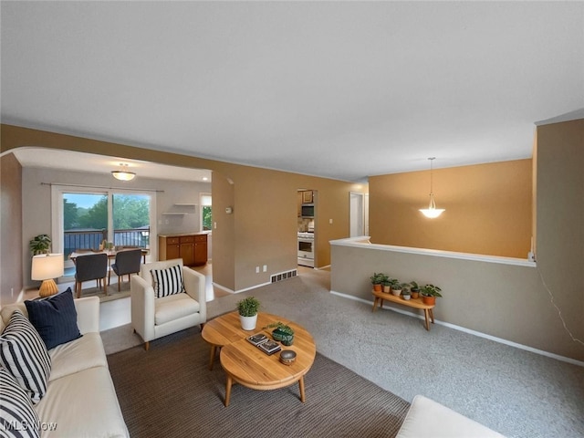 2330 Judy Dr, Parma, OH 44134 - living area featuring arched walkways, carpet floors, and baseboards