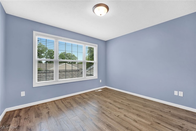 3527 Perry Ct, Lorain, OH 44053 - unfurnished room with wood finished floors and baseboards