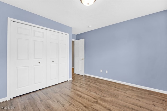 3527 Perry Ct, Lorain, OH 44053 - unfurnished bedroom with wood finished floors, baseboards, and a closet