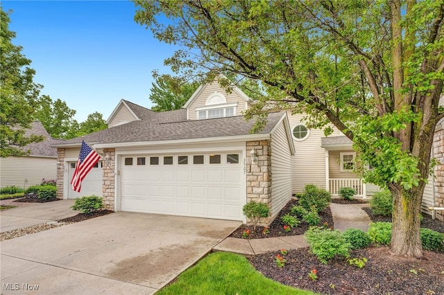 3527 Perry Ct, Lorain, OH 44053 - view of front of home featuring stone siding, concrete driveway, a garage, and roof with shingles