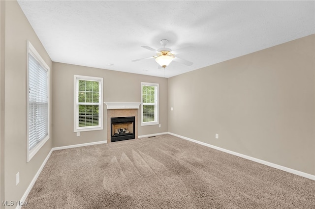 3527 Perry Ct, Lorain, OH 44053 - unfurnished living room featuring baseboards, carpet flooring, a fireplace with flush hearth, and a ceiling fan