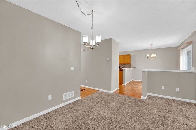 3527 Perry Ct, Lorain, OH 44053 - unfurnished room featuring a chandelier, light colored carpet, and baseboards