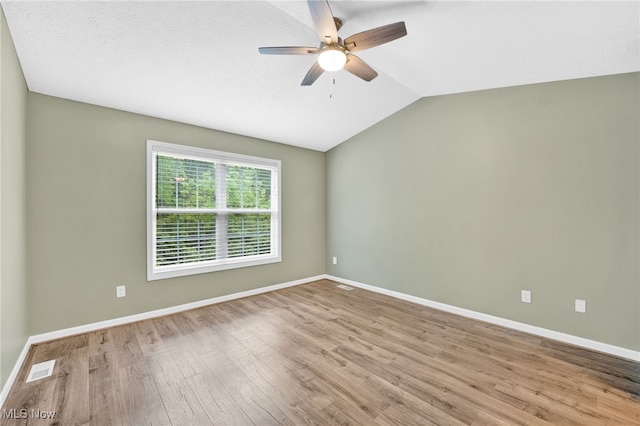 3527 Perry Ct, Lorain, OH 44053 - empty room with ceiling fan, wood finished floors, baseboards, and lofted ceiling