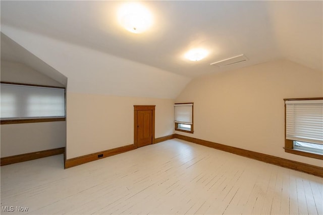 1477 Waterbury Rd, Lakewood, OH 44107 - additional living space featuring vaulted ceiling, baseboards, and light wood-type flooring