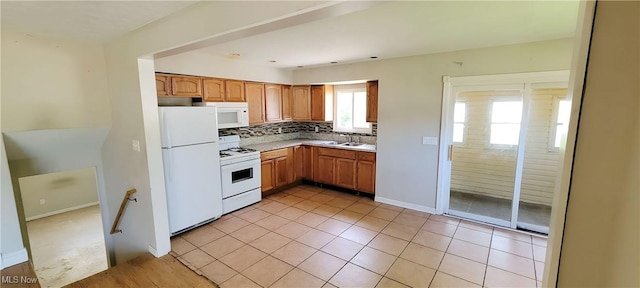 4321 W 181st St, Cleveland, OH 44135 - kitchen with white appliances, a sink, tasteful backsplash, light countertops, and light tile patterned floors