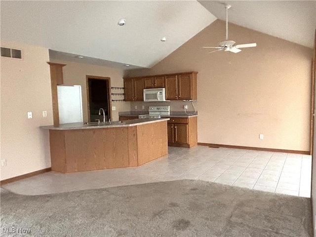 39 Village Ct, Columbiana, OH 44408 - kitchen featuring light tile patterned flooring, brown cabinets, electric range, a peninsula, and high vaulted ceiling