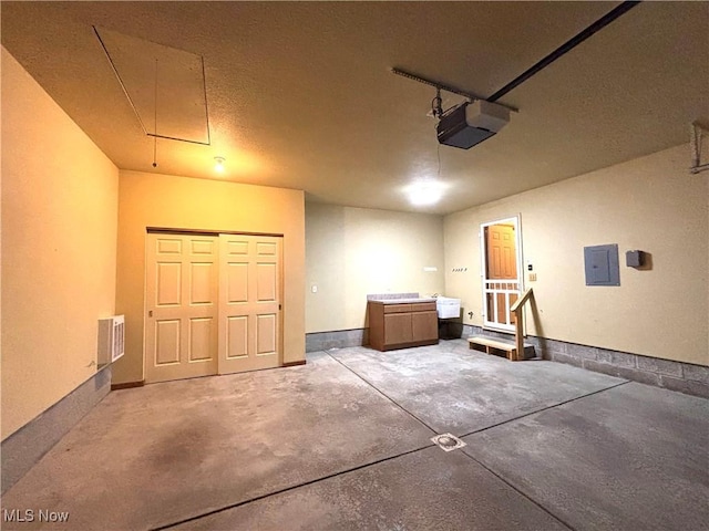 39 Village Ct, Columbiana, OH 44408 - garage featuring a garage door opener, electric panel, and baseboards