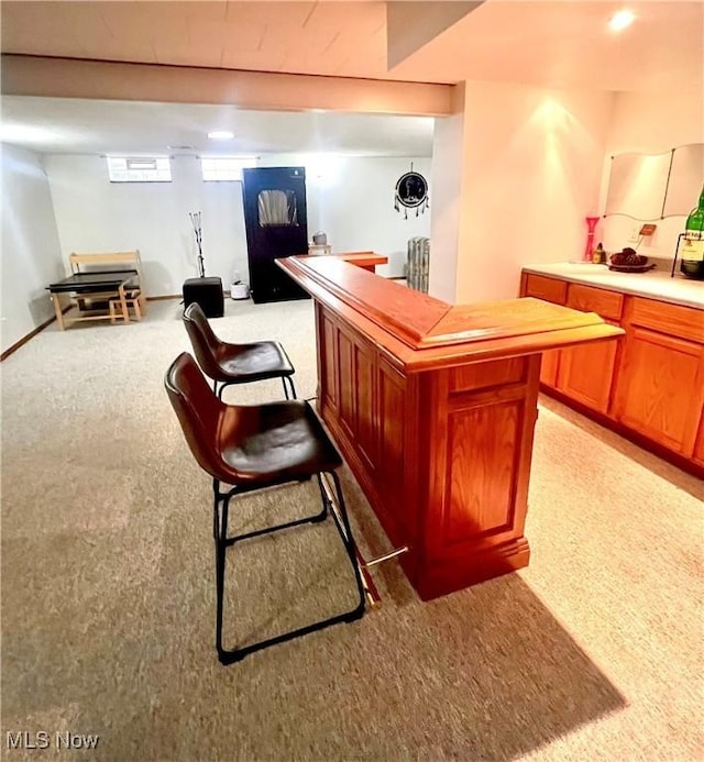 6101 Laurent Dr, Parma, OH 44129 - indoor dry bar with light colored carpet and radiator
