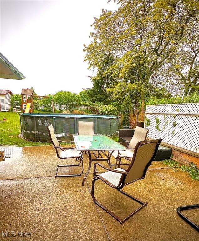 6101 Laurent Dr, Parma, OH 44129 - view of patio / terrace featuring outdoor dining space and a pool