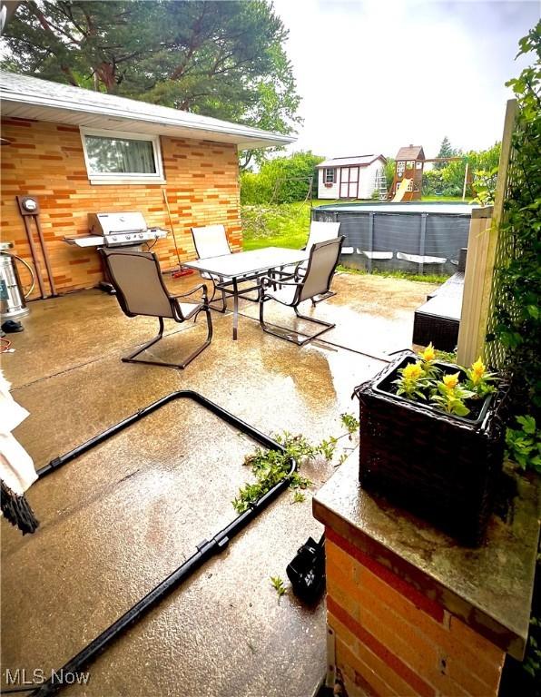 6101 Laurent Dr, Parma, OH 44129 - view of patio / terrace with outdoor dining space and a swimming pool