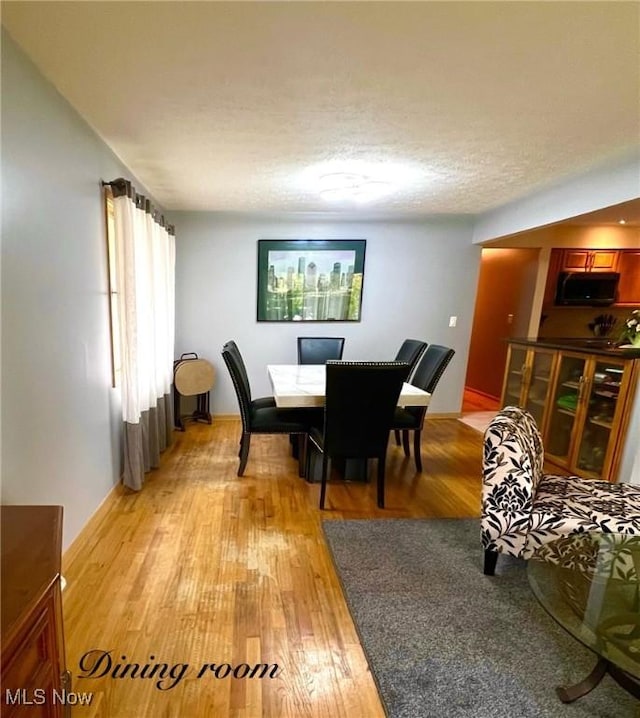 6101 Laurent Dr, Parma, OH 44129 - dining space with light wood-type flooring and a textured ceiling