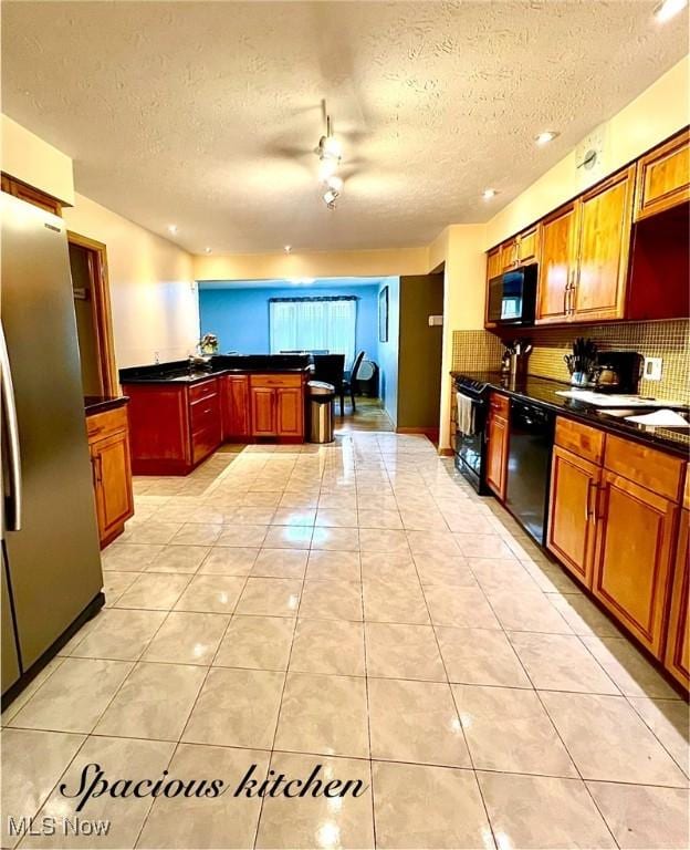 6101 Laurent Dr, Parma, OH 44129 - kitchen featuring black appliances, a textured ceiling, dark countertops, tasteful backsplash, and ceiling fan