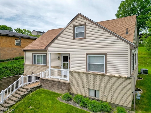 213 Pico St, Steubenville, OH 43952 - view of front of home with brick siding, a front lawn, central AC, and a shingled roof