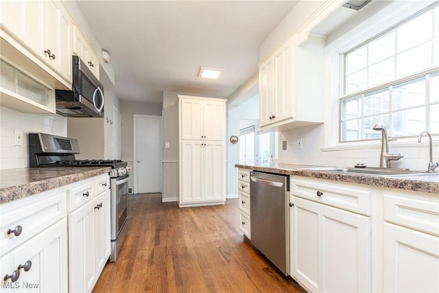 23935 Duffield Rd, Shaker Heights, OH 44122 - kitchen with appliances with stainless steel finishes, tasteful backsplash, a sink, dark wood-style floors, and white cabinets