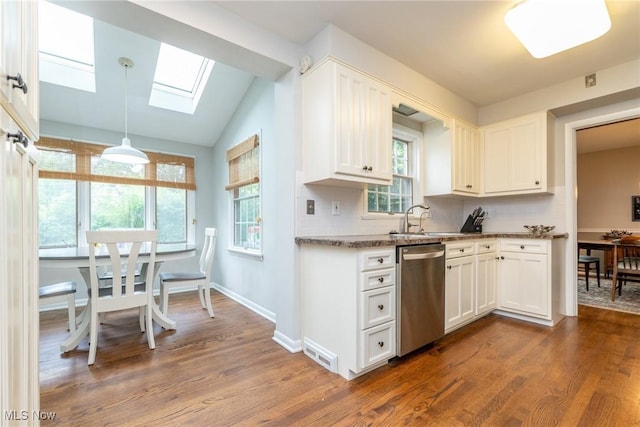 23935 Duffield Rd, Shaker Heights, OH 44122 - kitchen featuring stainless steel dishwasher, a sink, dark wood-type flooring, white cabinetry, and lofted ceiling