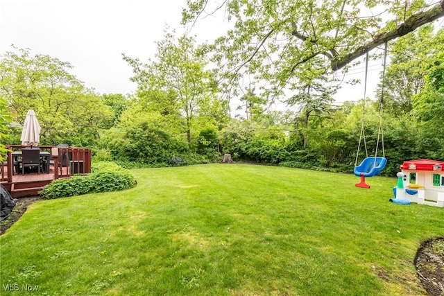 23935 Duffield Rd, Shaker Heights, OH 44122 - view of grassy yard featuring a playground, a deck, and outdoor dining area