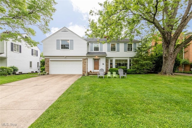 23935 Duffield Rd, Shaker Heights, OH 44122 - traditional home with a garage, concrete driveway, a front lawn, and stone siding