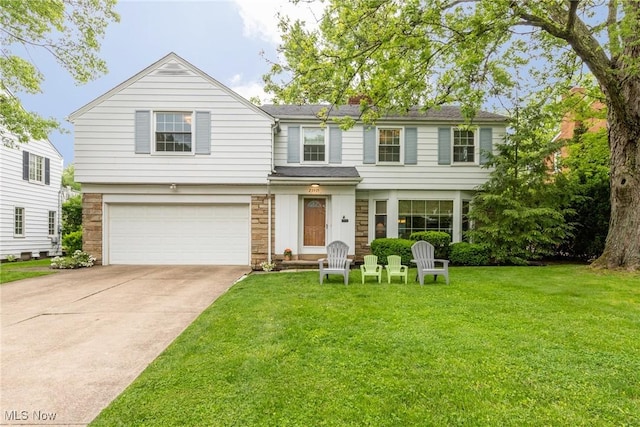 23935 Duffield Rd, Shaker Heights, OH 44122 - view of front of house with an attached garage, a front yard, driveway, and stone siding