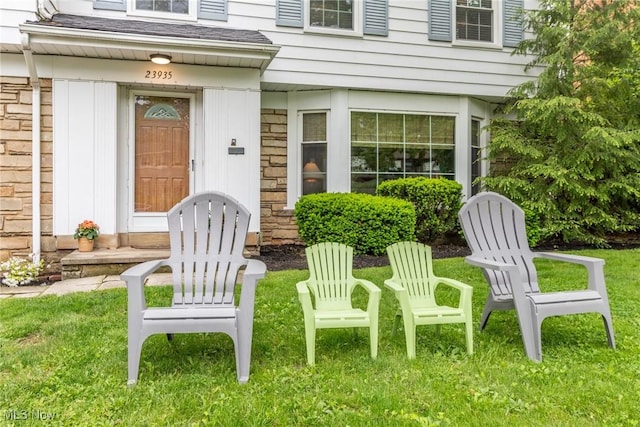 23935 Duffield Rd, Shaker Heights, OH 44122 - doorway to property featuring stone siding and a yard
