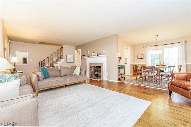 23935 Duffield Rd, Shaker Heights, OH 44122 - living area featuring light wood finished floors, stairs, and a fireplace with flush hearth