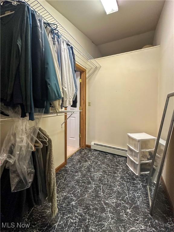 2308 Bears Den Rd, Youngstown, OH 44511 - spacious closet featuring a baseboard radiator, lofted ceiling, and marble finish flooring