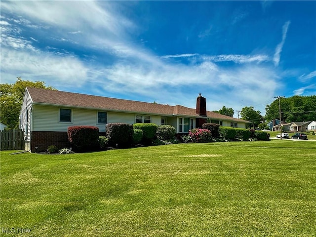 2308 Bears Den Rd, Youngstown, OH 44511 - back of house featuring a yard, a chimney, and brick siding