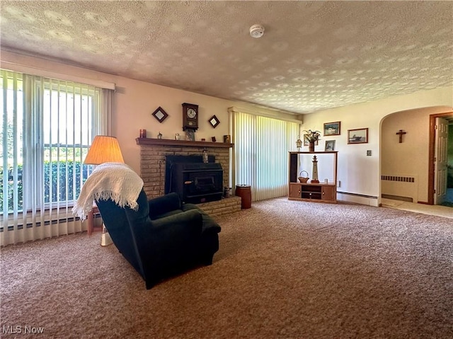 2308 Bears Den Rd, Youngstown, OH 44511 - living room with a textured ceiling, radiator heating unit, carpet flooring, arched walkways, and a baseboard radiator