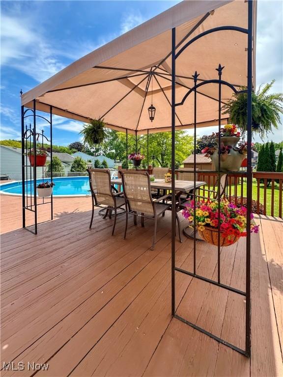 2308 Bears Den Rd, Youngstown, OH 44511 - deck featuring an outdoor pool and outdoor dining area