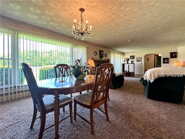 2308 Bears Den Rd, Youngstown, OH 44511 - dining area with carpet flooring, a textured ceiling, a chandelier, plenty of natural light, and arched walkways