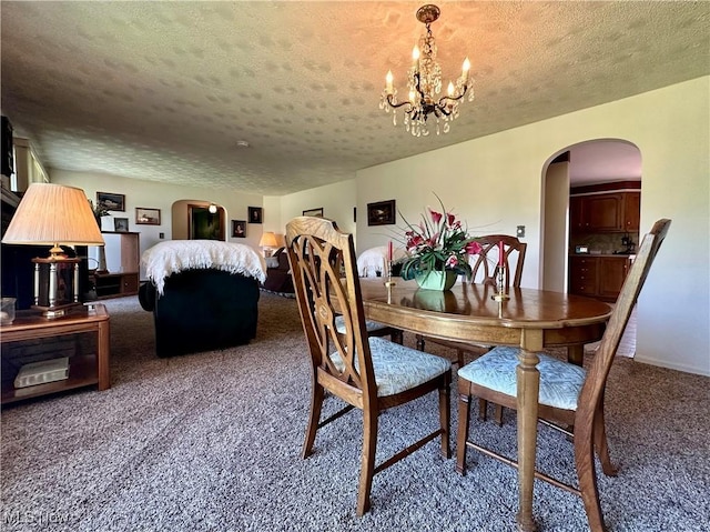 2308 Bears Den Rd, Youngstown, OH 44511 - carpeted dining space with arched walkways, a textured ceiling, a chandelier, and baseboards